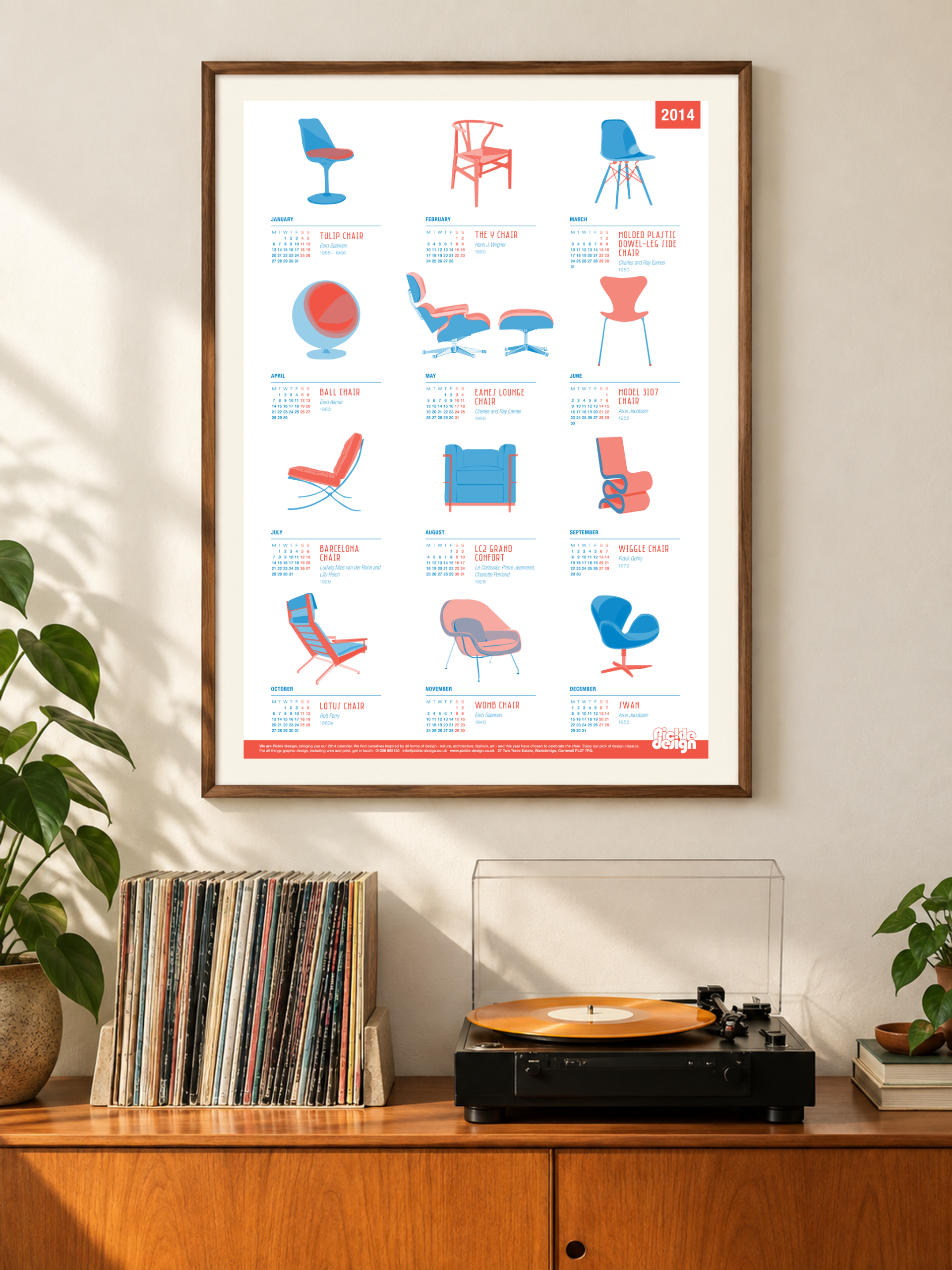 2014 Pickle Design calendar featuring illustrated classic chairs, framed above a record player