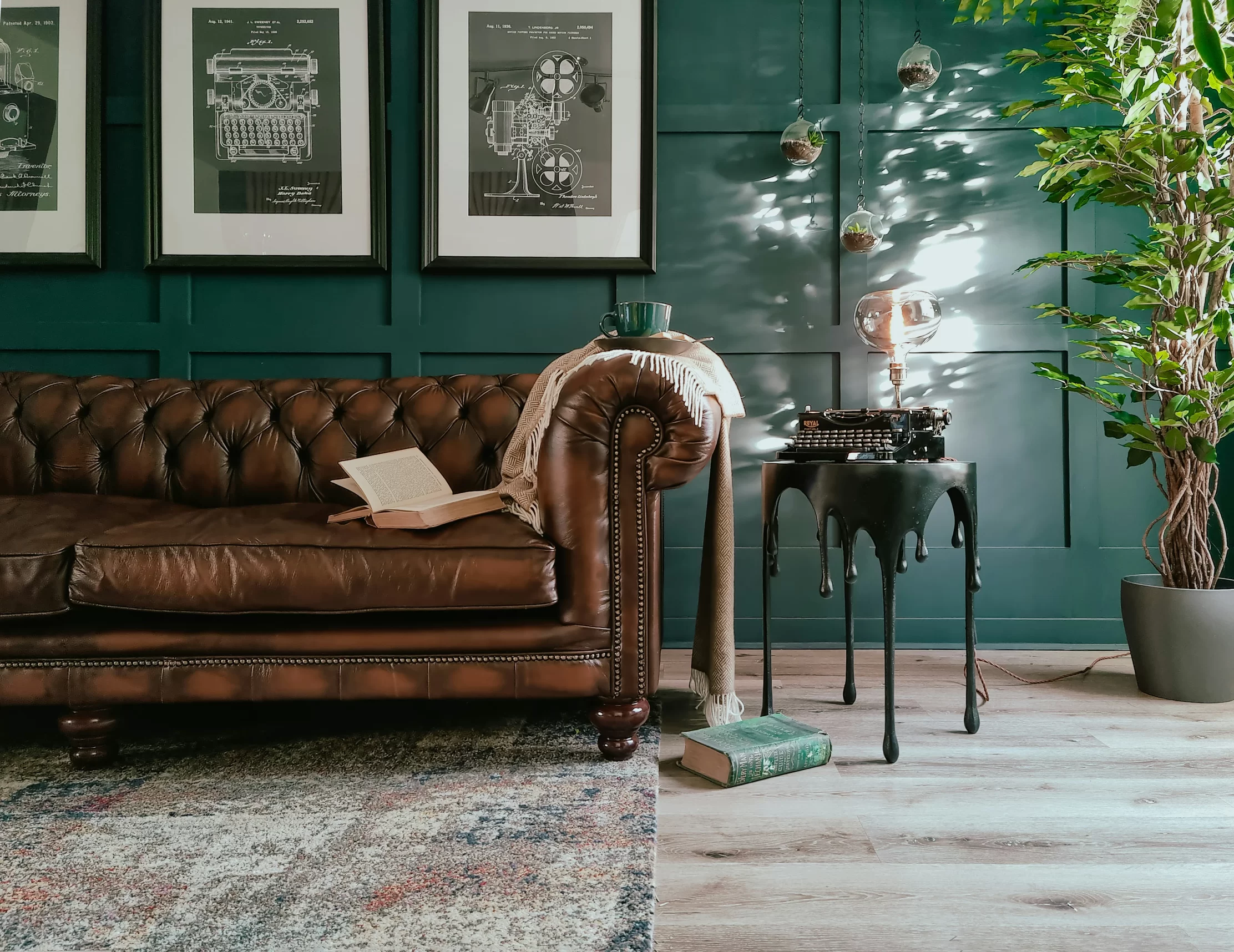 Brown leather Chesterfield sofa in a dark green contemporary interior