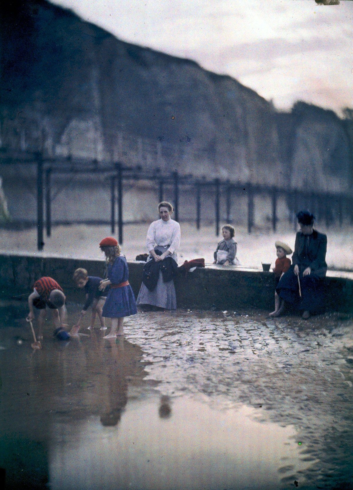 Early colour photograph of Victorian children playing by the sea