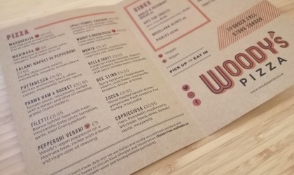 Woody's Pizza menu printed on brown paper