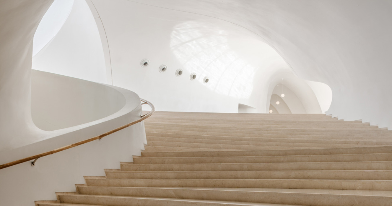 Wooden steps and curved white interior in amazing architecture