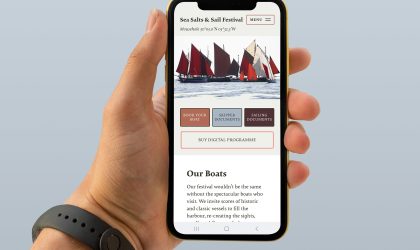 Mobile phone displaying the Sea Salts and Sail festival website and boat directory.