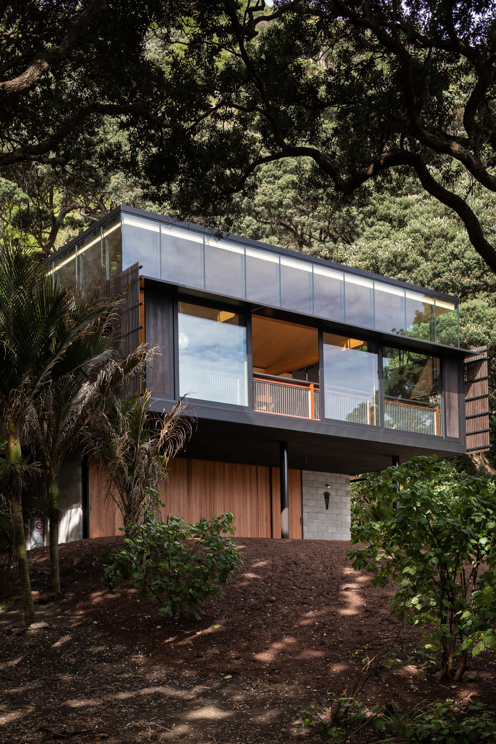 Giant boxy home high in the trees with sea views