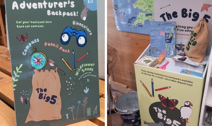 Lovat Holiday Parks Big Five Adventurer’s Backpack sign beside a borrowing station with maps, activity materials and reusable backpacks