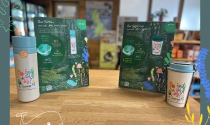 Lovat Holiday Parks reusable bottle and coffee cup displayed with illustrated sustainability point-of-sale boards